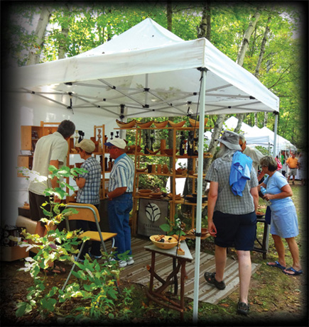 Artist Booths set up along riverbank and festival grounds.